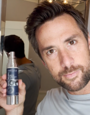 Man shows Particle skincare product.