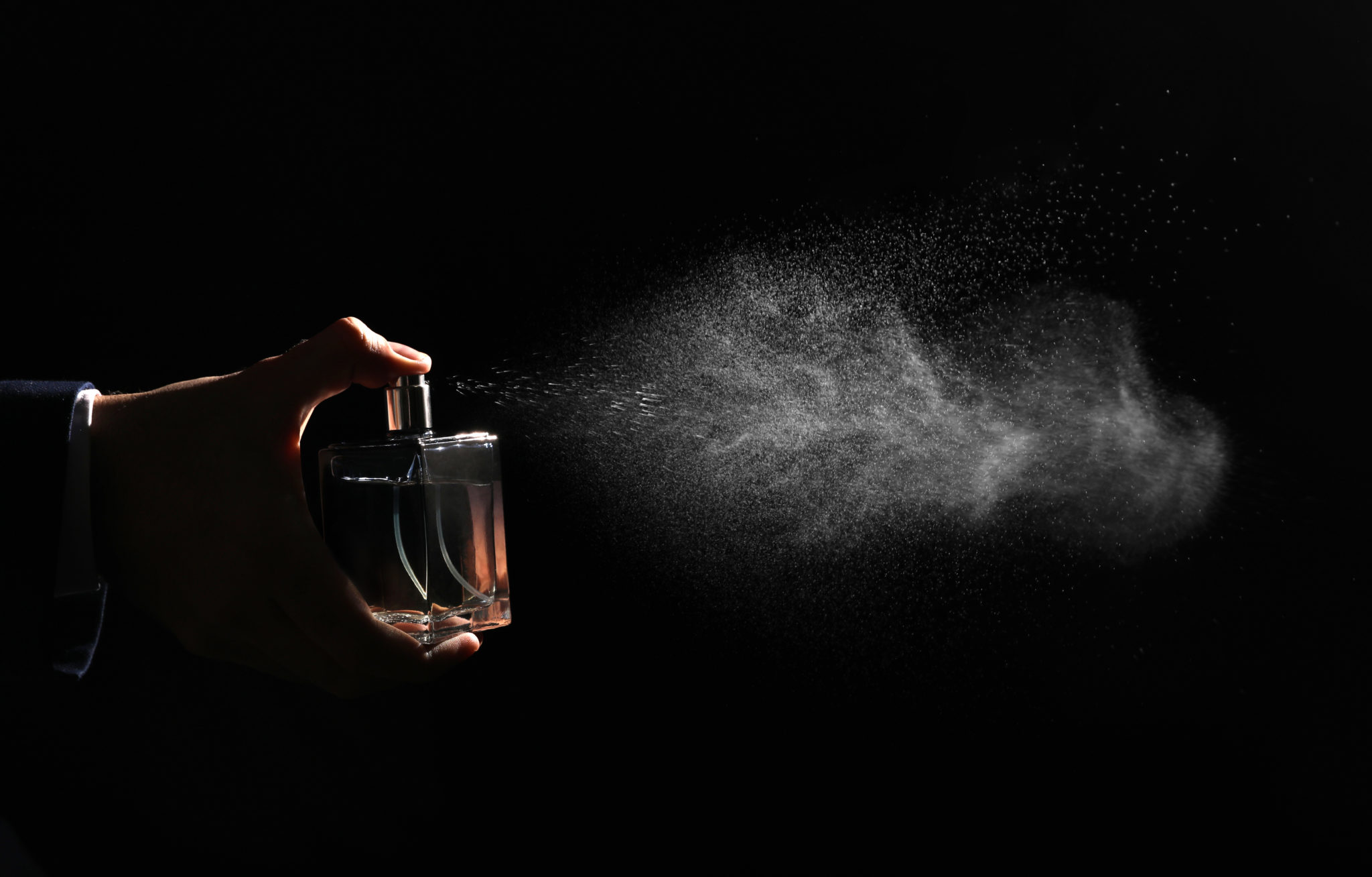 Man,Spraying,Luxury,Perfume,On,Black,Background,Closeup